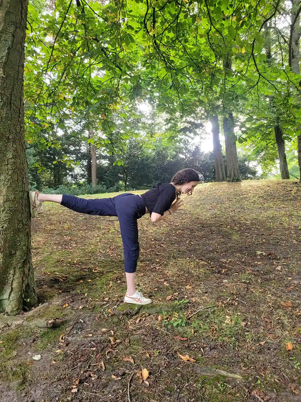 Dafna doing a yoga pose in a park in Groningen